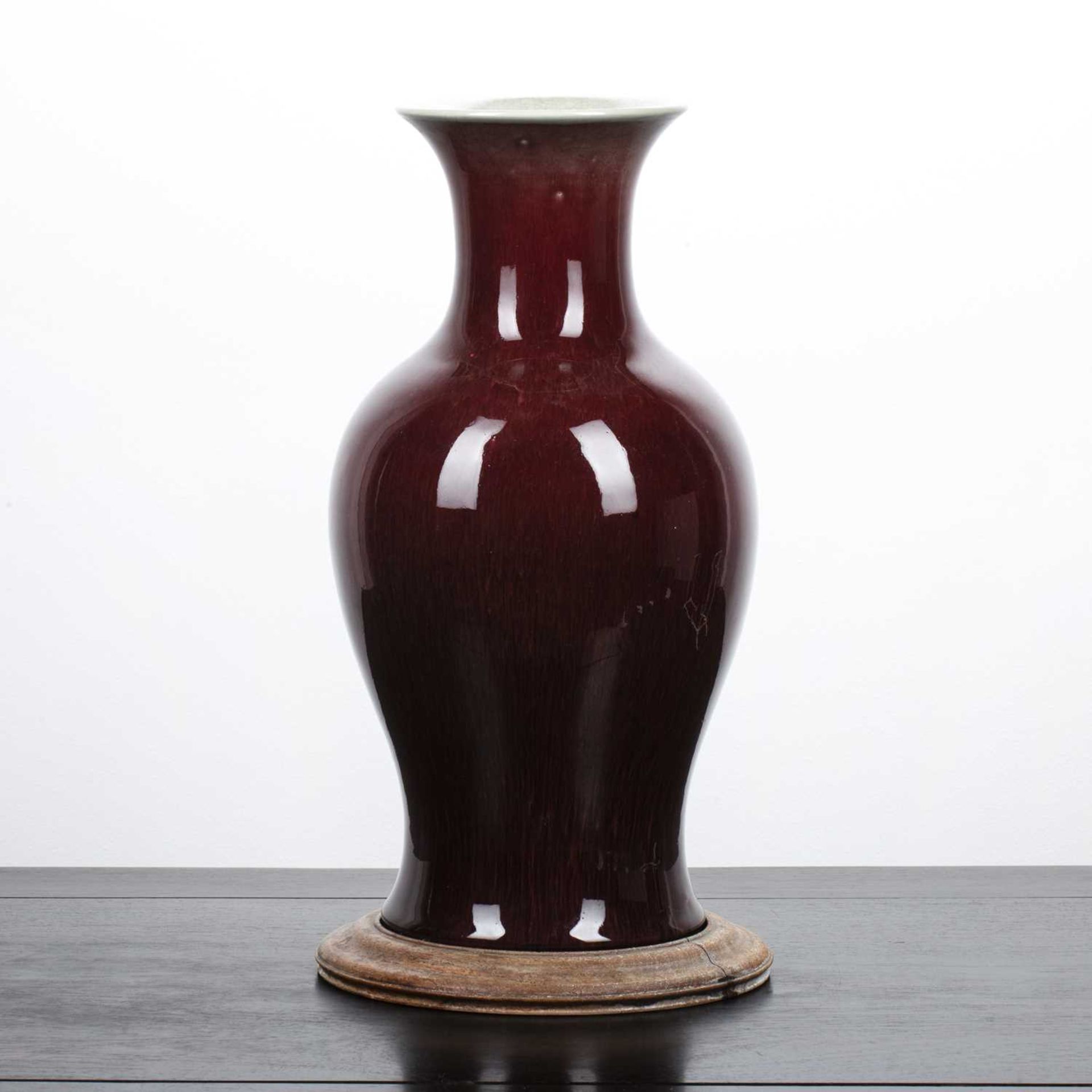 Sang de boeuf vase Chinese, 18th/ early 19th Century of baluster form, with a wooden stand, 35cm - Image 2 of 3