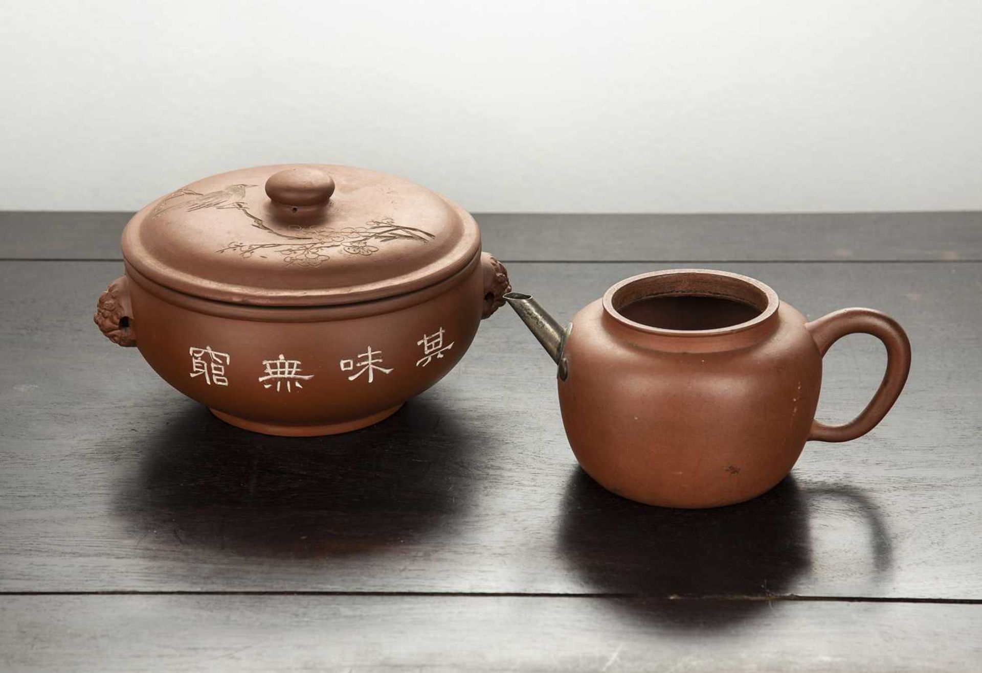 Two Yixing earthenware pieces Chinese to include a teapot, with two seal marks, 19cm across, and a
