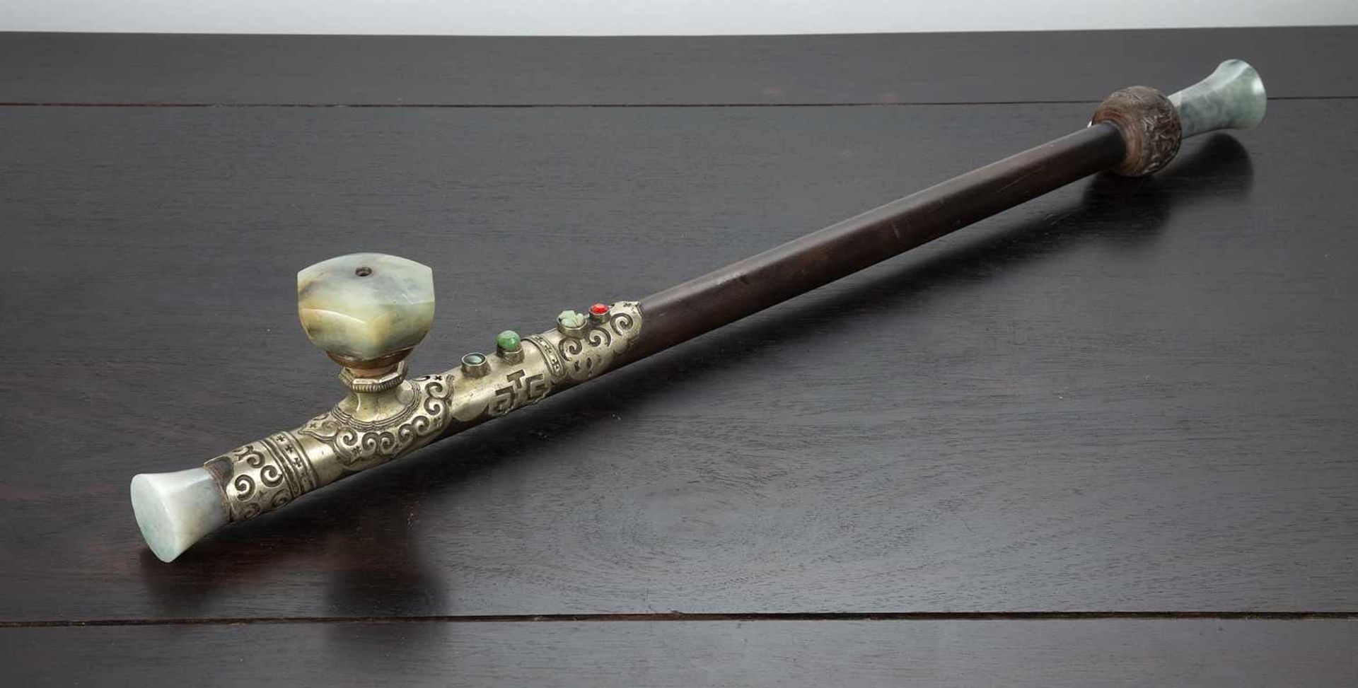 Opium pipe Chinese, late 19th Century having a hardwood stem with carved bowl, paktong saddle