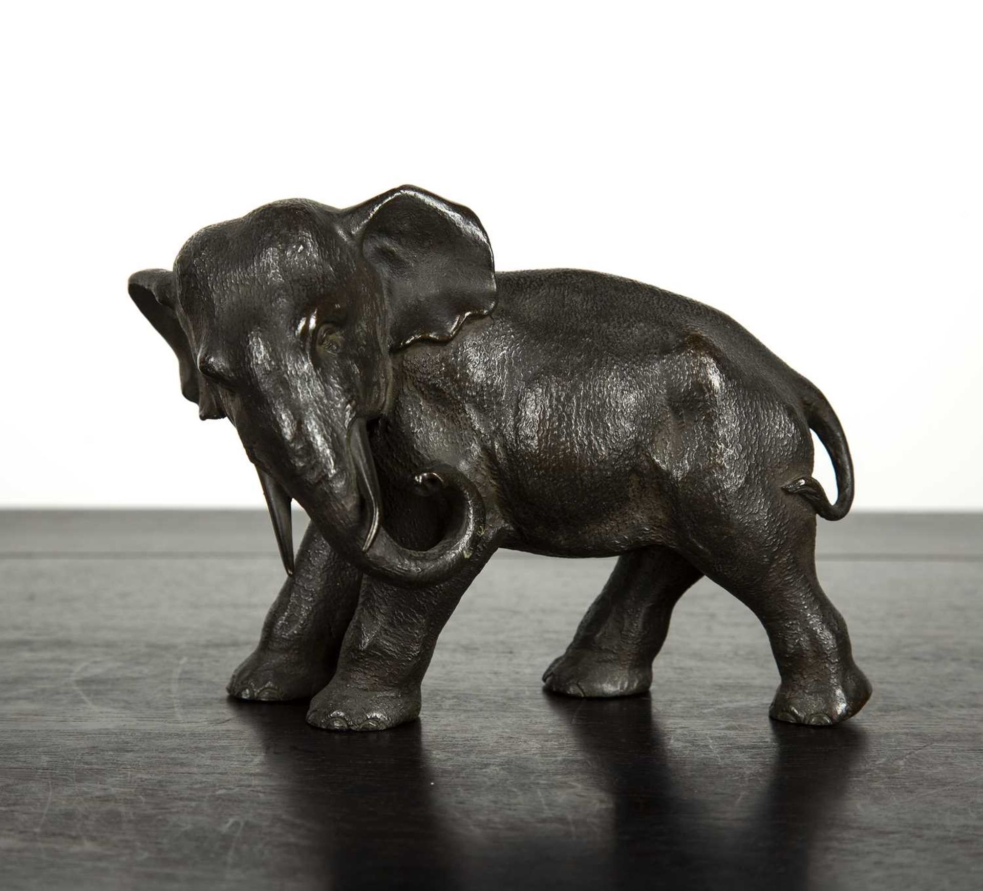 Bronze model elephant Japanese, Meiji period with its head turned to the left, signed to the base of