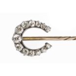 A diamond stick pin, the horseshoe-shaped terminal with graduated old-cut diamonds in claw settings,