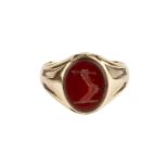 A late Victorian hardstone signet ring, the oval carnelian intaglio with incised crest, to a tapered