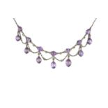 An amethyst and half pearl fringe necklace, designed as a series of oval mixed-cut amethysts