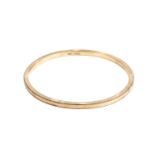 A 9ct gold slave bangle, of hollow form, with textured decoration, inner diameter 7.65cmGross weight
