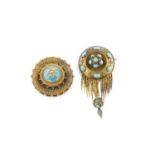 Two Victorian Archaeological Revival panel brooches, the first designed as a circular boss,