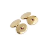 A pair of ruby set cufflinks, with oval panels and chain-link fittings, each cufflink inset with a