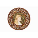 Aesthetic Movement Art pottery charger manufactured by Derby painted with a Pre-Raphaelite maiden in