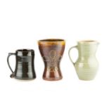 Leach Pottery An early mug treacle glaze with fleur-de-lis decoration 18cm high; and a Leach Pottery