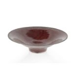 Abdo Nagi (1941-2001) Flared bowl red glaze with bronze rim impressed potter's seal 10.5cm high,