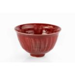 David Leach (1911-2005) Bowl with copper red glaze and fluted sides impressed potter's seal 11cm