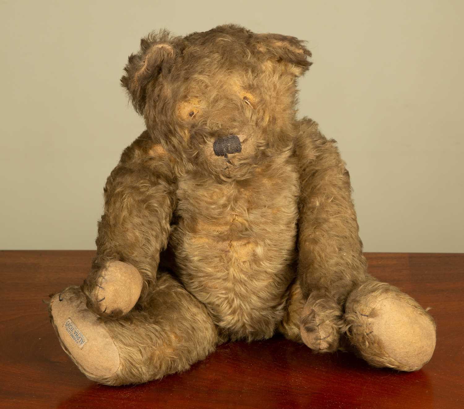 An early 20th century Farnel teddy bear with a 'Farnel's Alpha Toys' label to the foot, 46cm in