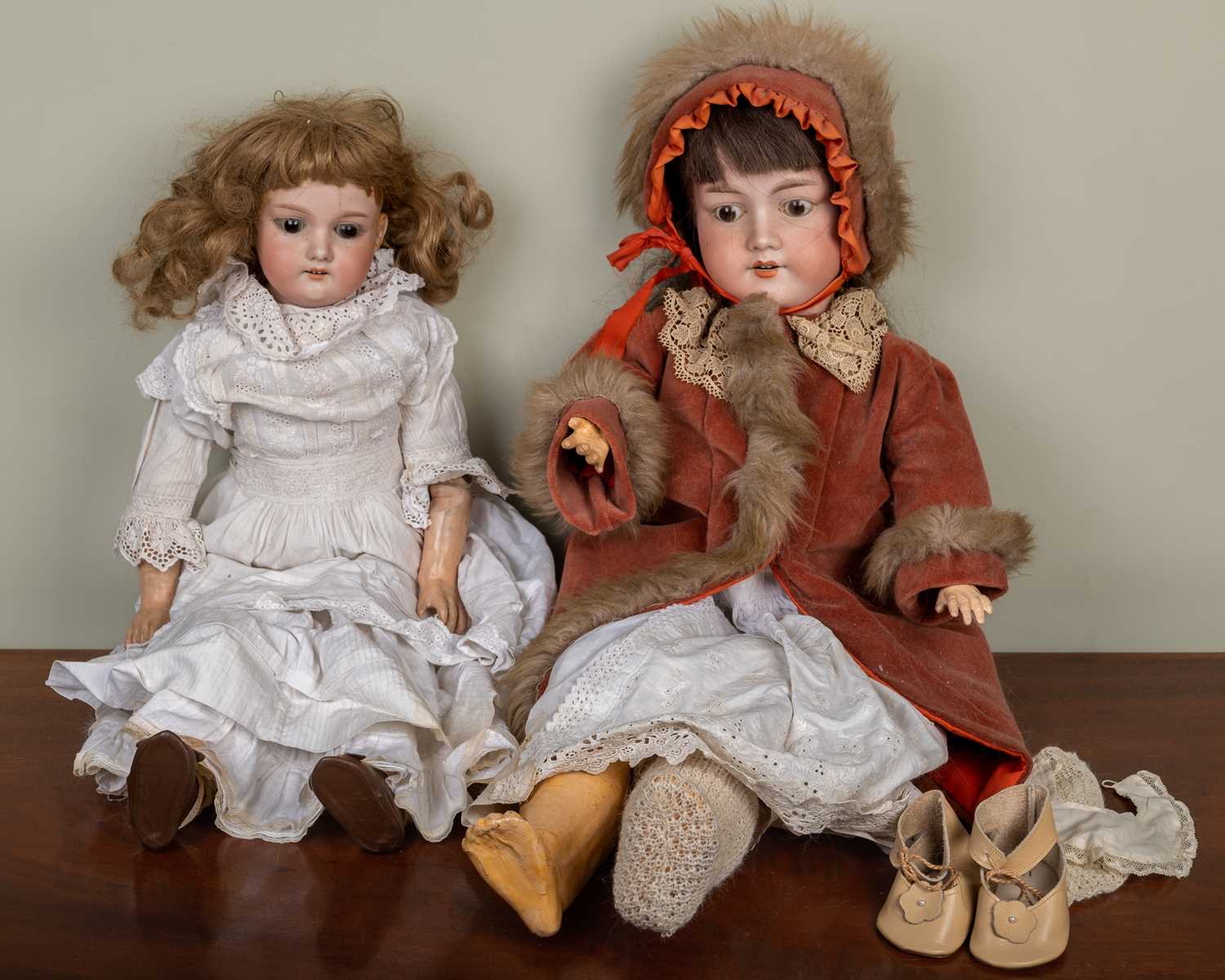 Two antique bisque headed dolls; one Armand Marseilles doll, the back of the head stamped with marks