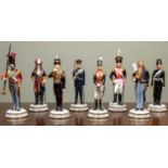 Eight Michael Sutty Porcelain figurines of soldiers from the Royal Artillery in uniforms from 1700