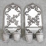 A pair of metal garden mirrors