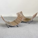 A pair of curved wicker log baskets