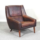 A mid 20th century brown leather upholstered armchair