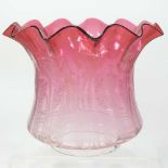 A red glass oil lamp shade