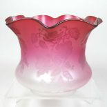 A red glass oil lamp shade