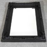 A black framed wall mirror
