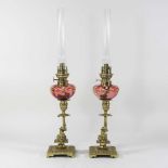 A pair of 19th century brass and cranberry glass oil lamps