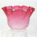 A red glass oil lamp shade