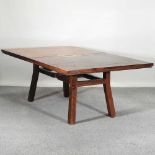 A contemporary inlaid hardwood dining table