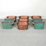 A set of four copper coloured metal planters