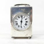 A miniature silver carriage clock