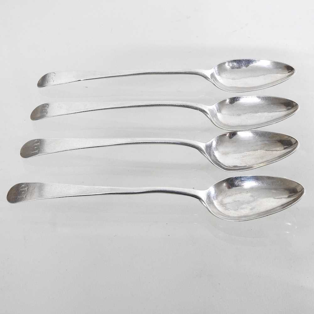 A collection of four Old English pattern silver teaspoons