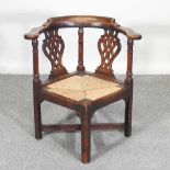 A George III oak and elm corner chair