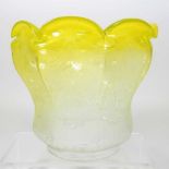 A yellow glass oil lamp shade