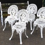 A set of four white painted metal chairs