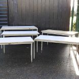 A set of five metal tables
