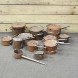 A collection of antique copper pans