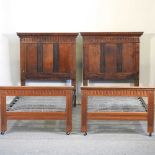 A pair of early 20th century carved oak single bedsteads