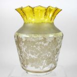 A yellow glass oil lamp shade