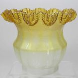 A yellow glass oil lamp shade