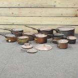 A collection of antique copper pans