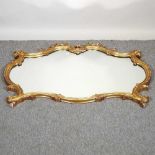 A gilt framed wall mirror