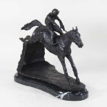 A bronze figure of a mounted jockey