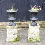 A pair of small cast iron garden planters