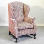 A Queen Anne style wingback armchair