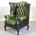 A green leather upholstered armchair