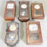 A collection of five wall clocks