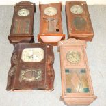 A collection of five wall clocks