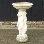 A cast stone bird bath