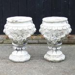 A pair of cast stone garden urns