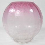 A pink glass oil lamp shade