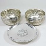 A pair of white metal bowls
