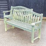 A pair of green painted wooden garden benches